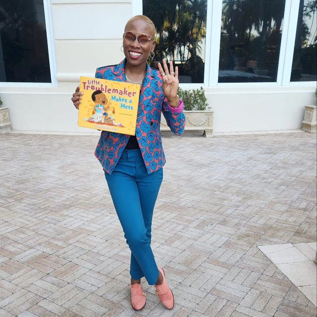 Luvvie holding Little Troublemaker Make A Mess Book
