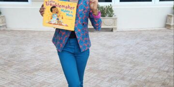 Luvvie holding Little Troublemaker Make A Mess Book