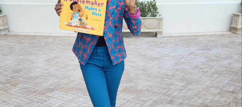 Luvvie holding Little Troublemaker Make A Mess Book
